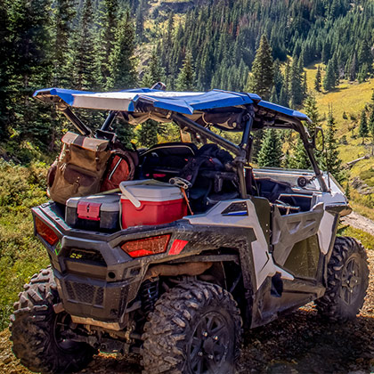 A RAZR loaded with gear in the mountains.