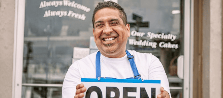 Business owner holding open sign