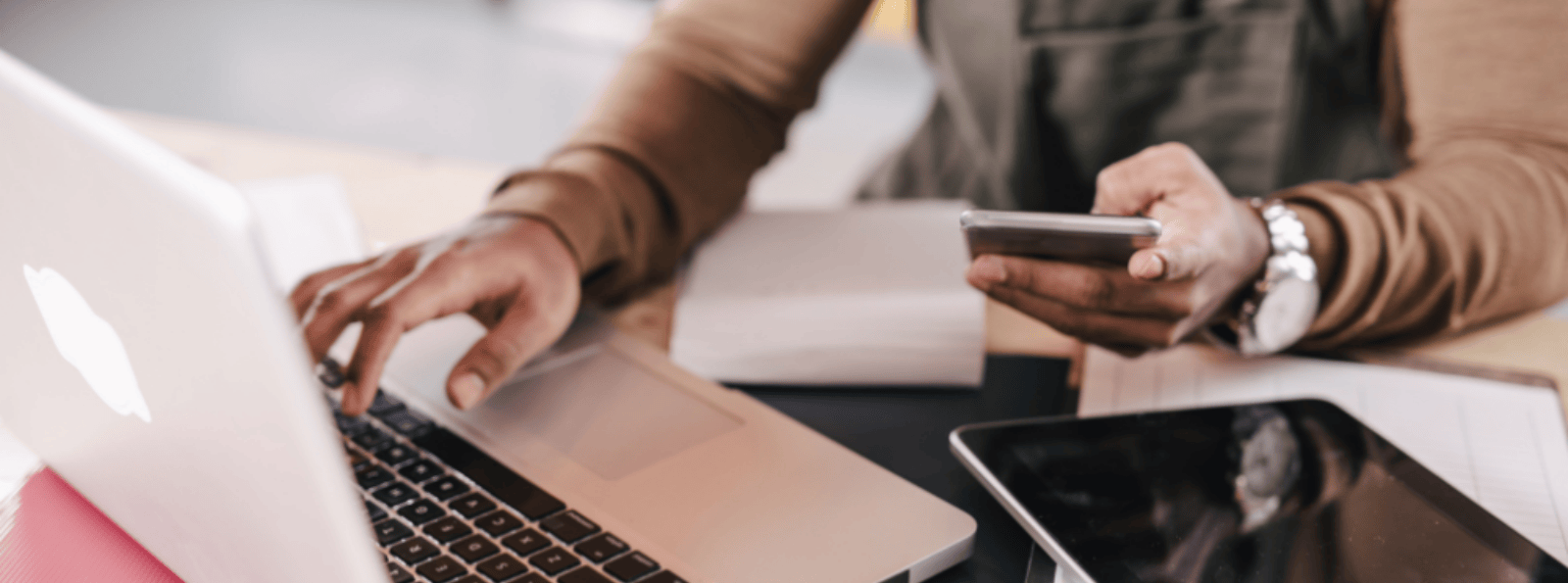 Business owner using mobile phone, tablet and laptop